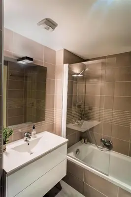 a bathroom with a sink and a bath tub at Modern 1-Bed Apt near Croisette Palais - 1903 in Cannes