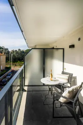 a balcony with a table and chairs on a building at Modern 1-Bed Apt near Croisette Palais - 1903 in Cannes