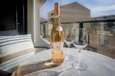 a bottle of wine sitting on a table with two wine glasses at Modern 1-Bed Apt near Croisette Palais - 1903 in Cannes