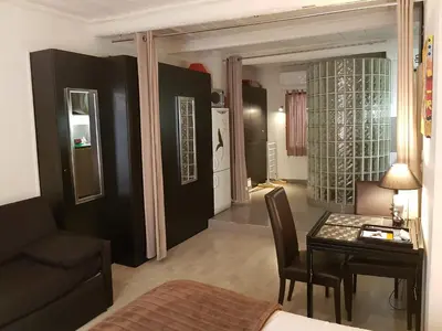 a living room with a table and a dining room at Notre Dame in Cannes
