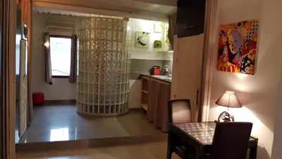 a living room with a table and a kitchen at Notre Dame in Cannes
