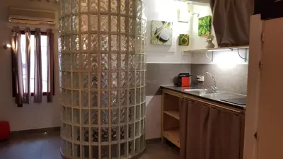 a kitchen with a tall wine bottle tower in a kitchen at Notre Dame in Cannes