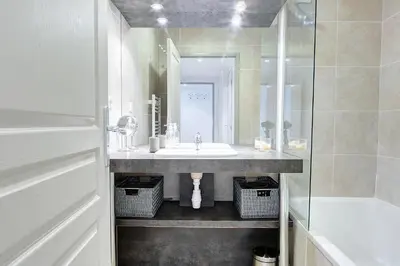 a white bathroom with a sink and a shower at IMMOGROOM - 8 min from the Palais - AC - Quai St Pierre in Cannes