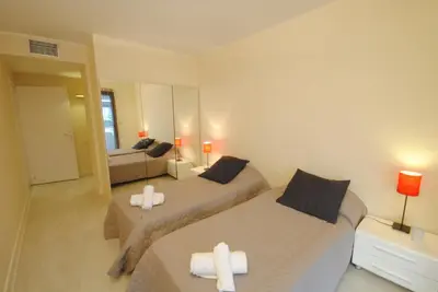 a bedroom with two beds and a mirror at Residence Gray d'Albion 2P ALI1165 in Cannes