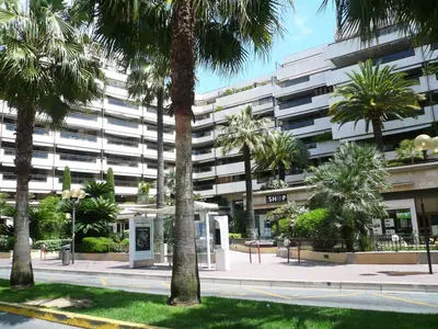 a large building with palm trees in front of it at Residence Gray d'Albion 2P ALI1165 in Cannes