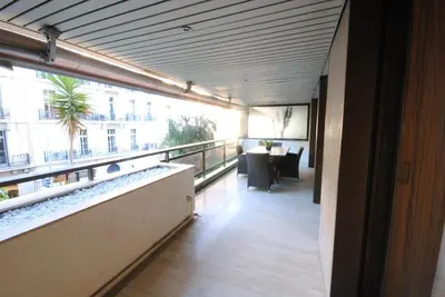 a room with a balcony with a table and a window at Residence Gray d'Albion 2P ALI1165 in Cannes