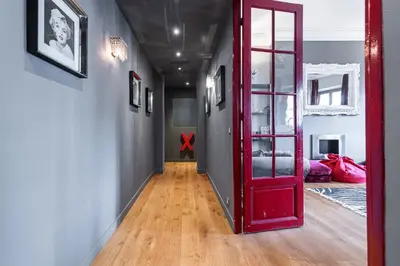 a red door leading to a hallway with a room at Travel lodge in Cannes