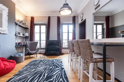 a kitchen with a bar with chairs and a table at Travel lodge in Cannes