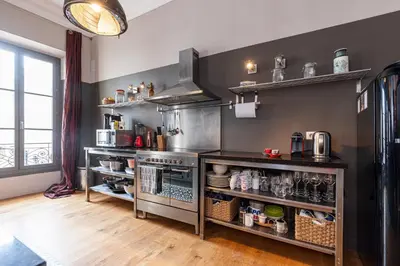 a kitchen with stainless steel appliances and a large window at Travel lodge in Cannes
