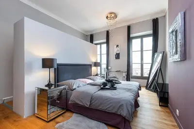 a bedroom with a large bed and a large window at Travel lodge in Cannes