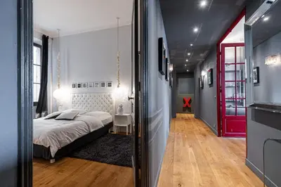 a bedroom with a bed and a red door at Travel lodge in Cannes