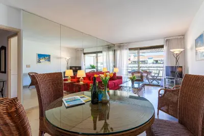 a living room with a table and a red couch at Residence Gray d'Albion 2P BLA584 in Cannes