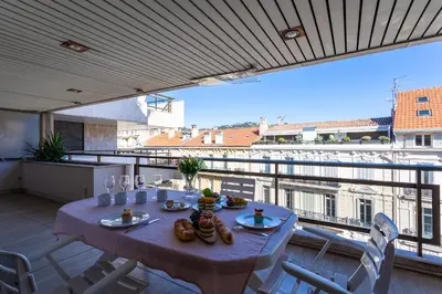 a table on a balcony with a view of the city at Residence Gray d'Albion 2P BLA584 in Cannes