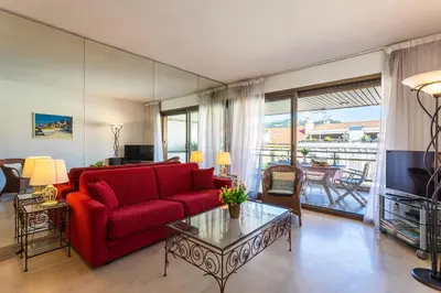 a living room with a red couch and a table at Residence Gray d'Albion 2P BLA584 in Cannes