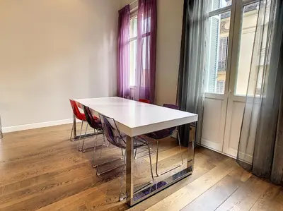 a white table and chairs in a room with a window at Le Cid 3P CIR3374 in Cannes