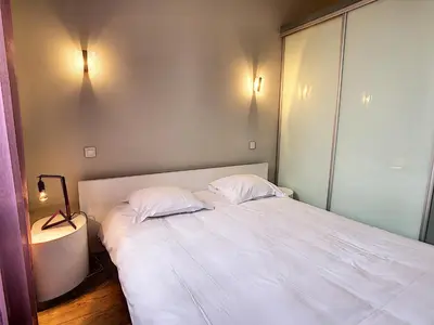 a bedroom with a large white bed with two pillows at Le Cid 3P CIR3374 in Cannes