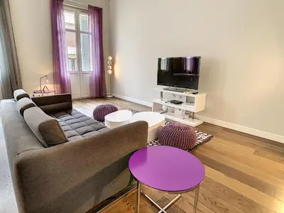 a living room with a couch and a tv at Le Cid 3P CIR3374 in Cannes