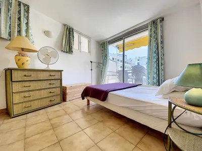 a bedroom with a large bed and a window at Palais Rouaze 2P SOM2151 in Cannes