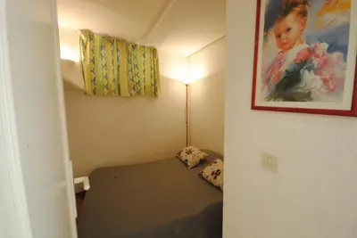 a small room with a bed and a painting on the wall at Palais Rouaze 2P SOM2151 in Cannes