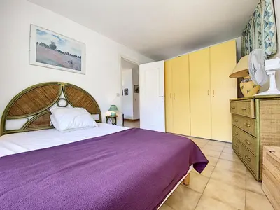 a bedroom with a large purple bed and yellow cabinets at Palais Rouaze 2P SOM2151 in Cannes