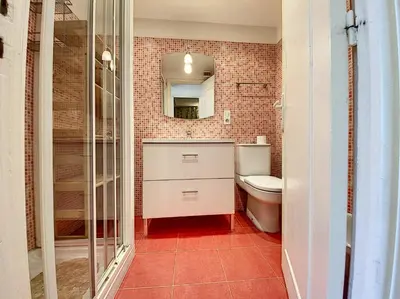 a bathroom with a toilet and a sink and a mirror at Palais Rouaze 2P SOM2151 in Cannes