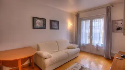 a living room with a white couch and a table at 2 Pièces 57 Rue d'Antibes proche Palais in Cannes