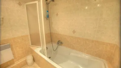 a bathroom with a bath tub with a shower at 2 Pièces 57 Rue d'Antibes proche Palais in Cannes