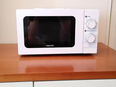 a white microwave sitting on top of a counter at 2 Pièces 57 Rue d'Antibes proche Palais in Cannes