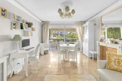 a living room with a table and chairs and a desk at Appartement CANNES IMPERIAL Pointe Croisette in Cannes