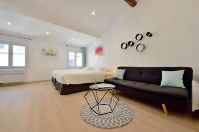 a living room with a bed and a couch at Studio Elly in Cannes