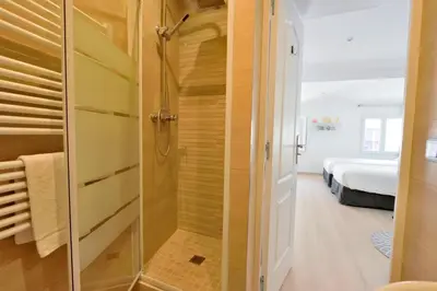 a bathroom with a shower with a glass door at Studio Elly in Cannes
