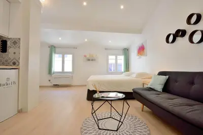 a living room with a bed and a couch at Studio Elly in Cannes