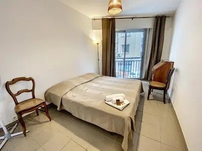 a room with a bed and two chairs and a window at Palm d'Or KAR146 2P in Cannes
