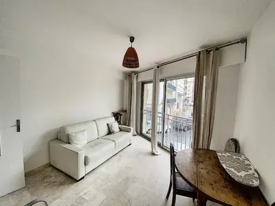 a living room with a couch and a table at Palm d'Or KAR146 2P in Cannes