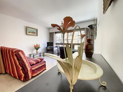 a living room with a table and a couch at Gray d'Albion studio BON500 in Cannes