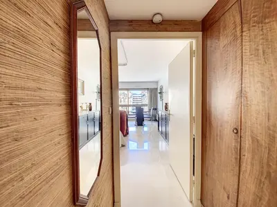 a hallway with a mirror and wooden walls at Gray d'Albion studio BON500 in Cannes