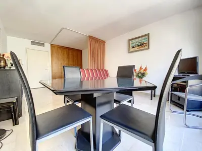 a dining room with a table and chairs at Gray d'Albion studio BON500 in Cannes