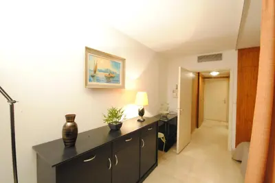 a room with a black dresser with a lamp on it at Gray d'Albion studio BON500 in Cannes