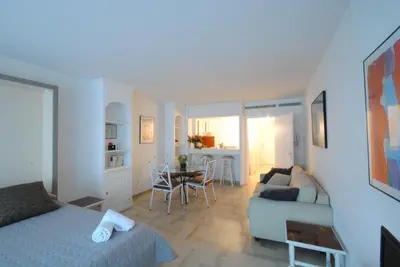 a room with a bed and a couch and a table at Residence Gray d'Albion Studio DEL186 in Cannes