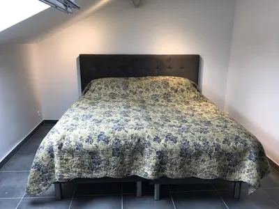 a bed in a room with a blanket on it at Cannes center in Cannes