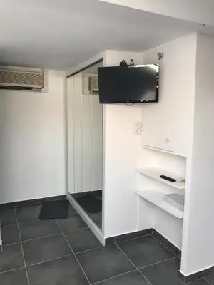 a room with white walls and a tv on the wall at Cannes center in Cannes