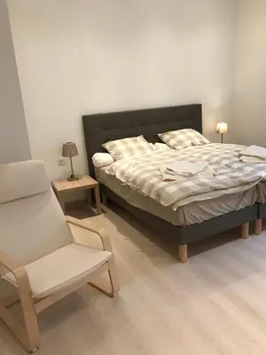 a bedroom with a bed and a chair and a chair at Cannes center in Cannes