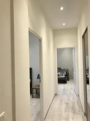 a hallway with a mirror and a bed in a room at Cannes center in Cannes