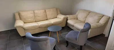 a living room with two couches and a table and chairs at Cannes center in Cannes