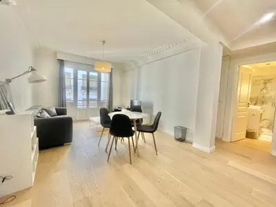 a living room with a table and chairs at Pasteur by Welcome to Cannes in Cannes