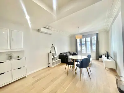a white living room with a table and chairs at Pasteur by Welcome to Cannes in Cannes