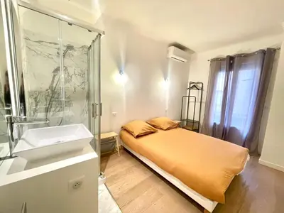 a bathroom with a bed and a shower and a sink at Pasteur by Welcome to Cannes in Cannes