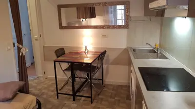a small kitchen with a table and a sink at Forville in Cannes