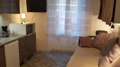 a living room with a couch and a microwave at Forville in Cannes