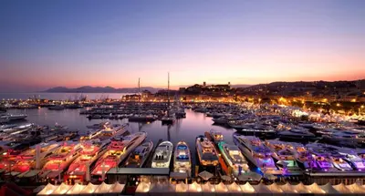 a group of boats docked in a marina at night at les orangers in Cannes